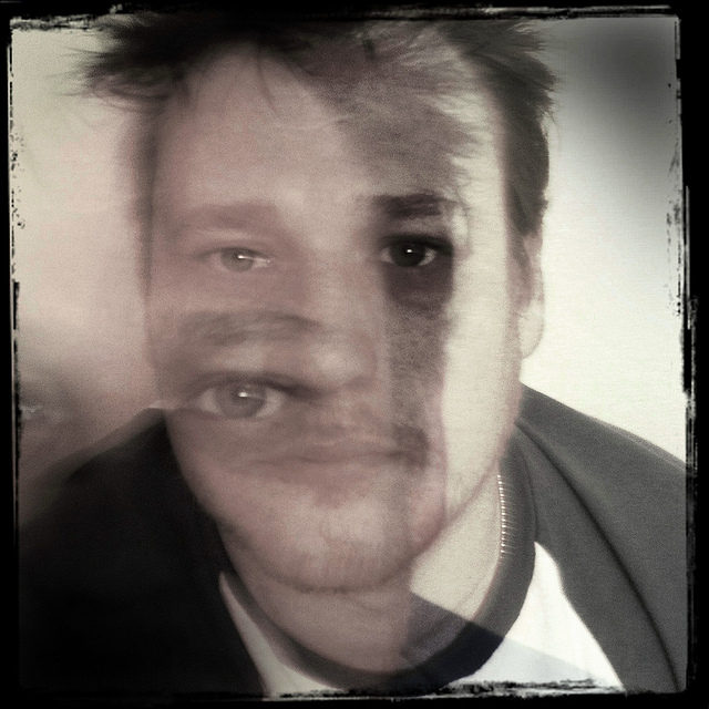 Blurry picture of a man showing a second image of his face detached from the first.