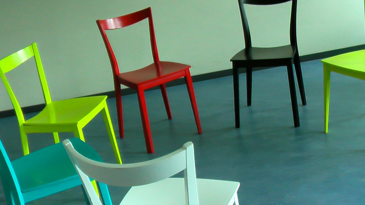 Colorful chairs set up in a circle for group therapy.