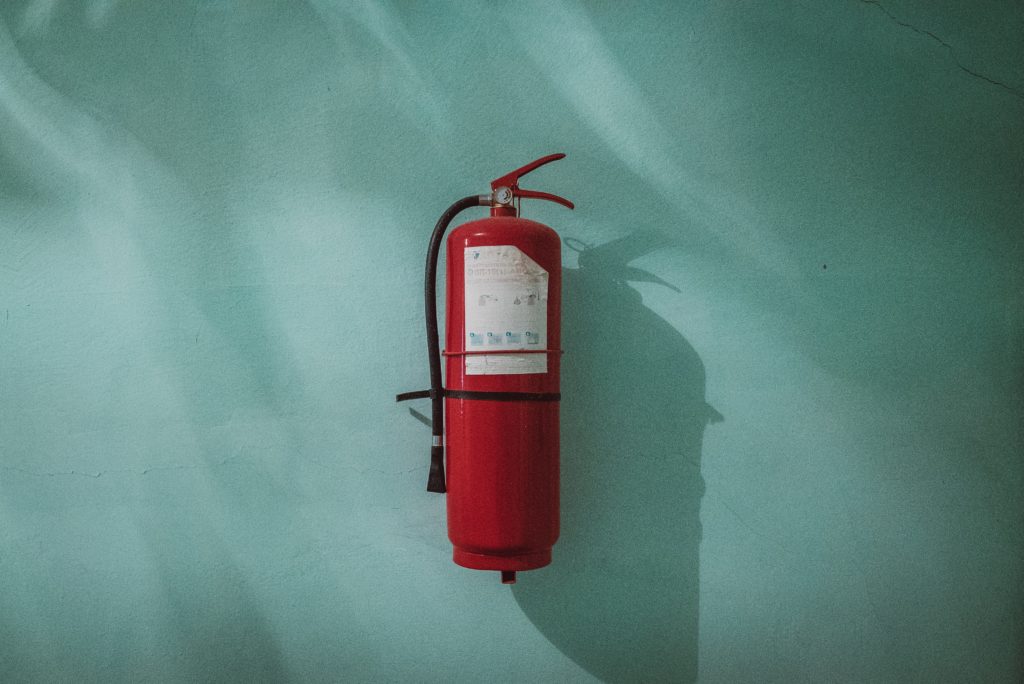 Photograph of a fire extinguisher secured to a wall
