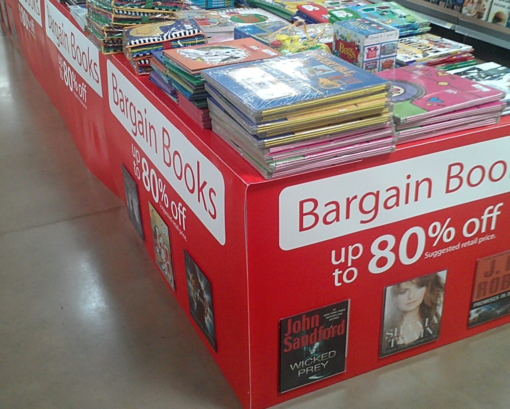 a dump bin full of books with a sign labeling them up too 80 percent off