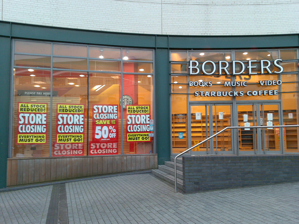Front of a Borders store with signs in the front windows saying 