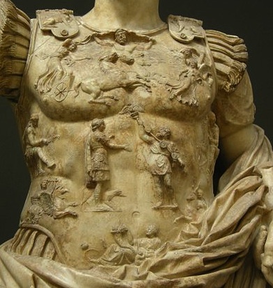 Up close photograph of the statue's breastplate. All features visible are discussed in the body text.